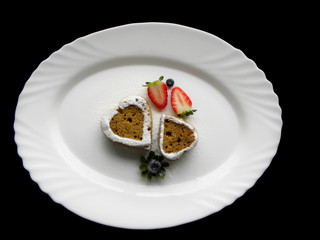 two heart-shaped pies on a white plate on a black background