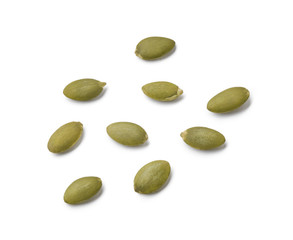 Raw pumpkin seeds isolated on white background. Top view