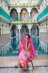 Obraz premium Portrait beautiful Asian Muslim or Indian woman Indian style beside the pool in a Muslim house.