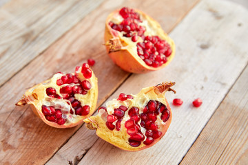ripe organic pomegranate on teh wooden background