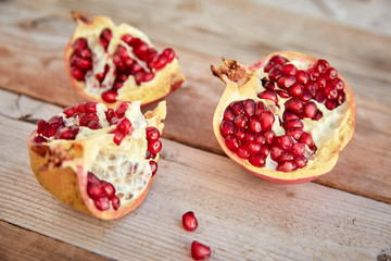 ripe organic pomegranate on teh wooden background