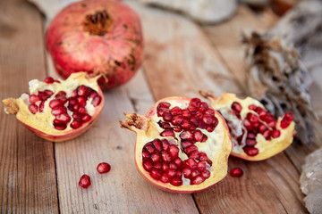 ripe organic pomegranate on teh wooden background