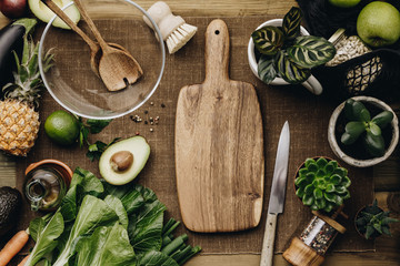 Fresh organic ingredients for salad making on rustic background