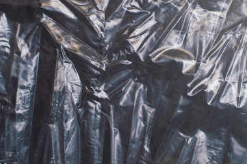 crumpled glossy dark polyethylene texture