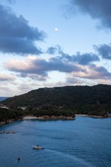 Haiti peninsula with day moon and sunset clouds