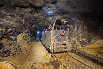 Underground gold mine shaft tunnel drift with old electric locomotive