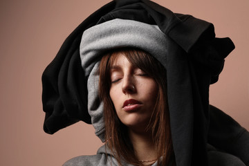 Close-up portrait of a young woman wearing a clothing on her head. Global consumption concept.