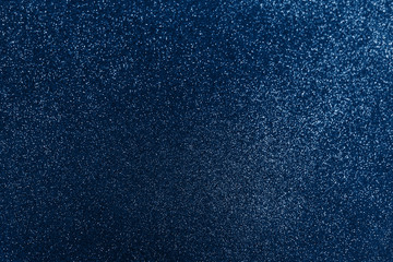 Glowing sparkles on blue color trendy background. Holiday bright brilliant beautiful background, template for blog or designers. Classic Flat lay. New Year 2020