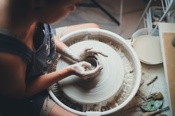 Shot of a unrecognizable woman molding clay on a pottery wheel in Her Workshop, Creative People...