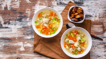 Food banner. Soup with turkey meat, potatoes, carrots, noodles and croutons. Homemade delicious dinner
