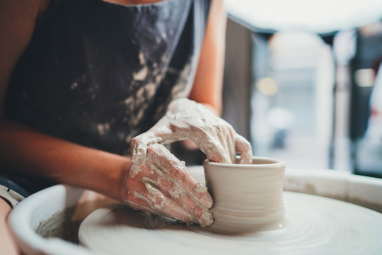 It's All About Form! Closeup Image Of Female Ceramic Artist Working With Pottery Wheel Makes Shape Of Future Mug, Process In Pottery Workshop Creative People Handmade Products