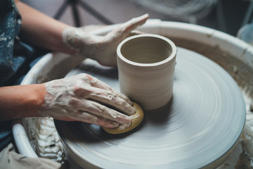 Closeup shot of female ceramic artist works on pottery wheel in studio space, Creative People Handcrafted Ceramic Design Art Skill - obrazy, fototapety, plakaty