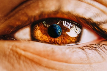Close-up of planet earth in the ye of a child. View of a child on the environmental world.