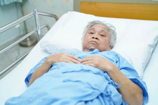 Asian senior or elderly old lady woman patient bright face while sitting in  nursing hospital ward, healthy strong medical concept. Stock Photo