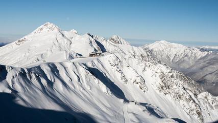 Mountain peaks of the Caucasus at Krasnaya Polyana, the village Rosa Khutor, winter sports resort...