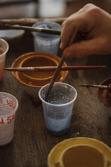 Craftsman decorates handmade terracotta