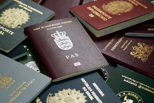 Various passports of the world with a passport of Denmark in the center.
