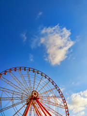 Part of ferris wheel with  soft clouds at sunset