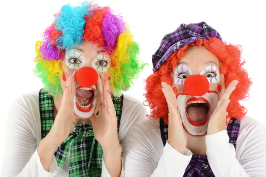 Women dressed in clown costume for carnival are silly and funny