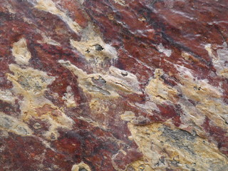 Stone wall texture in brown, red and white colors