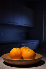 Oranges in a dark kitchen