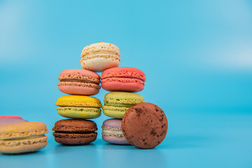 Assorted colorful macaroons  on blue background, copy space