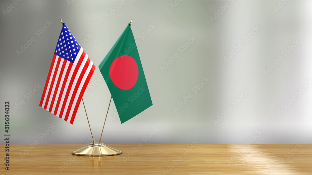 Wall mural American and Bangladesh flag pair on a desk over defocused background 