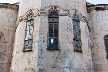Obraz premium Narrow Vertical blue Windows of the Church, the castle with a wall of gray old brick.