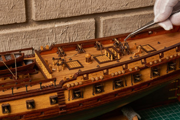 Ship model building in progress. Assembly of ship model from wood