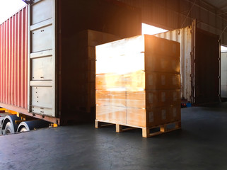 Packaging Boxes Stacked Wrapped Plastic on Pallets Loading into Shipping Cargo Container. Loading Dock. Delivery Trucks. Supply Chain Distributions. Cargo Shipment. Freight Truck Transport. Logistics	