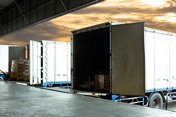 Cargo Container Trucks Parked Loading at Dock Warehouse. Shipment. Packaging Boxes Supply Chain....