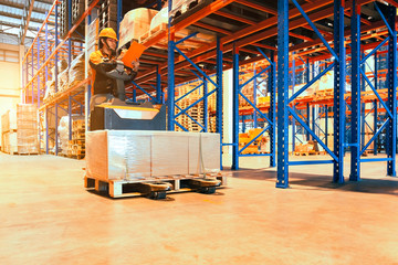 Interior of warehouse worker driving forklift with cargo pallet, Worker inspecting details checklist of the products on tall shelves