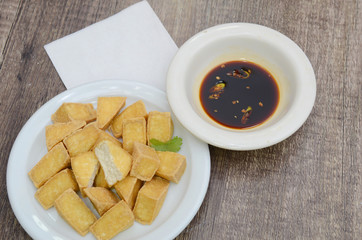 Fried tofu bubble meal on wooden