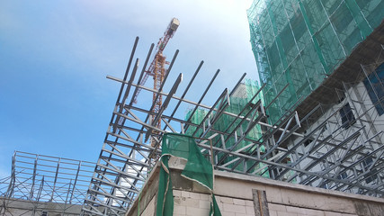 KUALA LUMPUR, MALAYSIA -JUNE 16, 2019: Lightweight roof trusses under construction at the construction site. Installed properly by workers to received the roof covering system. 