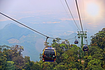 Overhead Cable Car hanging and moving on cable lines of Skybridge over forest which on mountain. ILLUSTRATION ASIA TRAVEL CONCEPT. Transportation in natural landscape areas of Ba Na Hills, Vietnam.