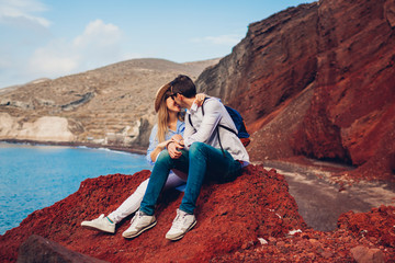 Valentines day. Couple in love enjoying honeymoon on Red beach in Santorini island, Greece. Vacation and traveling