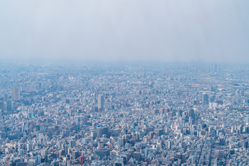 dust during daytime in a very polluted city - in this case Tokyo, Japan. Cityscape of buildings with bad weather from Fine Particulate Matter. Air pollution.