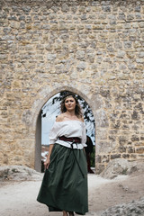 Fototapeta na wymiar Portrait of woman wearing medieval European maidservant clothes on outdoors. Festival in Óbidos Portugal
