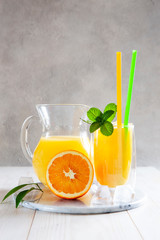 Natural freshly squeezed orange juice with ice and mint in a glass © Eleonora