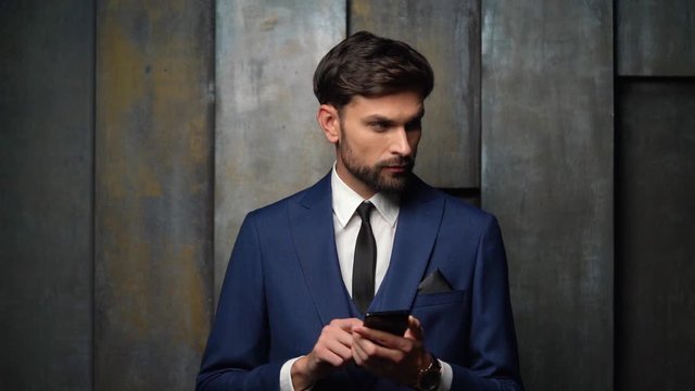 full hd video of young handsome stylish businessman - 4x slow motion - using smartphone