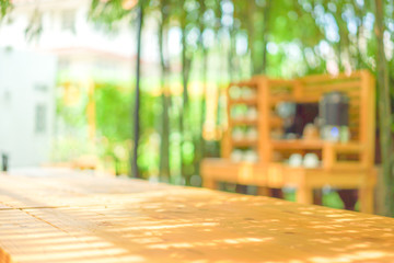 Shining sunlight through batterns on the table top in front of blur green garden background for package shot concept.