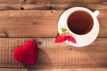 a cup of tea, heart, poinsettia, top view on a rustic background. Valentine's Day