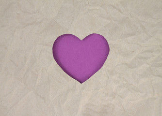 Violet felt heart on craft paper. Crumpled paper texture. Valentine's day stock photo for web, print and wallpaper.With empty space for text.