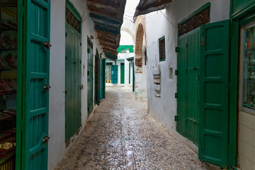 Green wooden doors of the old stores in Tetouan Medina quarter in Northern Morocco. A medina is...