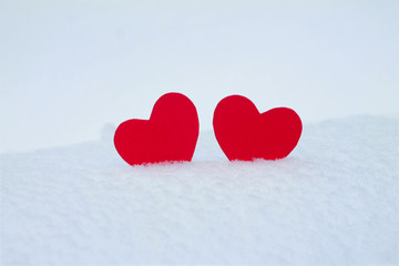 Two red felt hearts on the snow. Handmade for the celebration and holiday. Stock Photography for Valentine's Day with empty space for your text. For web, print, cards, invitations and wallpapers.