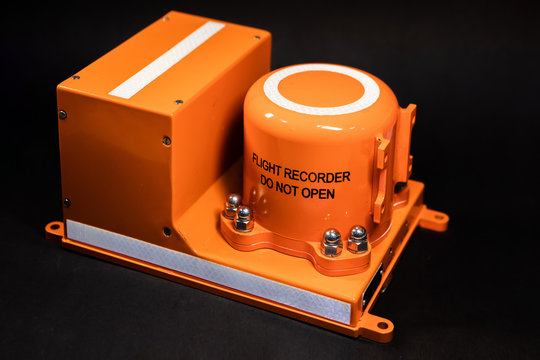 Aircraft flight data recorder on black background. Black Box in orange-colored armored steel