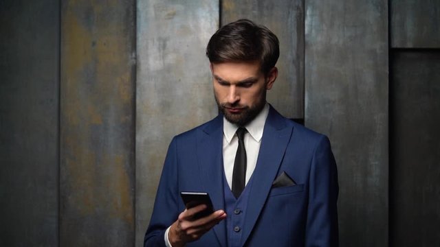 full hd video of young handsome stylish businessman - 4x slow motion - using smartphone