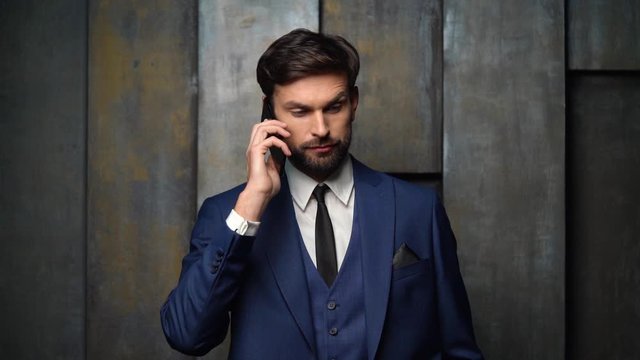 full hd video of young handsome stylish businessman - 4x slow motion - using smartphone