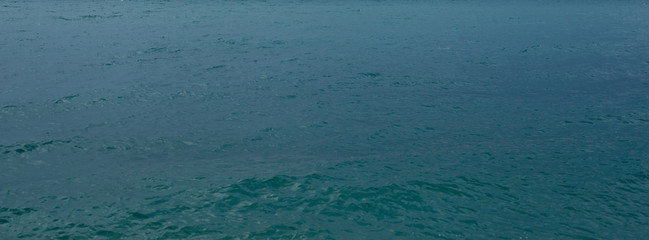 blue sea and cloudy sky over it