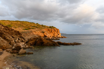Fototapeta na wymiar Beautiful rocky coastline and blue sea at sunset